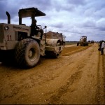A man operates a bulldozer during the leveling of and upgrading of a road base in Cambodia. Photo by Asian Development Bank, taken on 15 February 2011. Licensed under CC BY-NC-ND 2.0.