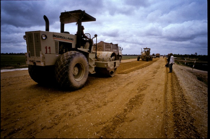 A man operates a bulldozer during the leveling of and upgrading of a road base in Cambodia. Photo by Asian Development Bank, taken on 15 February 2011. Licensed under CC BY-NC-ND 2.0.