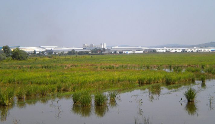 Sihanoukville's Special Economic Zone (SSEZ) as seen from National Highway No. 4 near Ream commune, Cambodia. Photo by Wikirictor via WikiMedia Commons, taken 15 October 2014. Licensed under CC BY-SA 3.0.